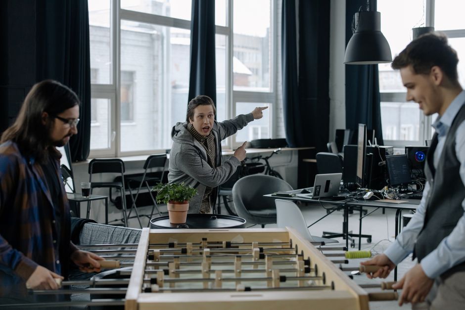 Young professionals playing foosball