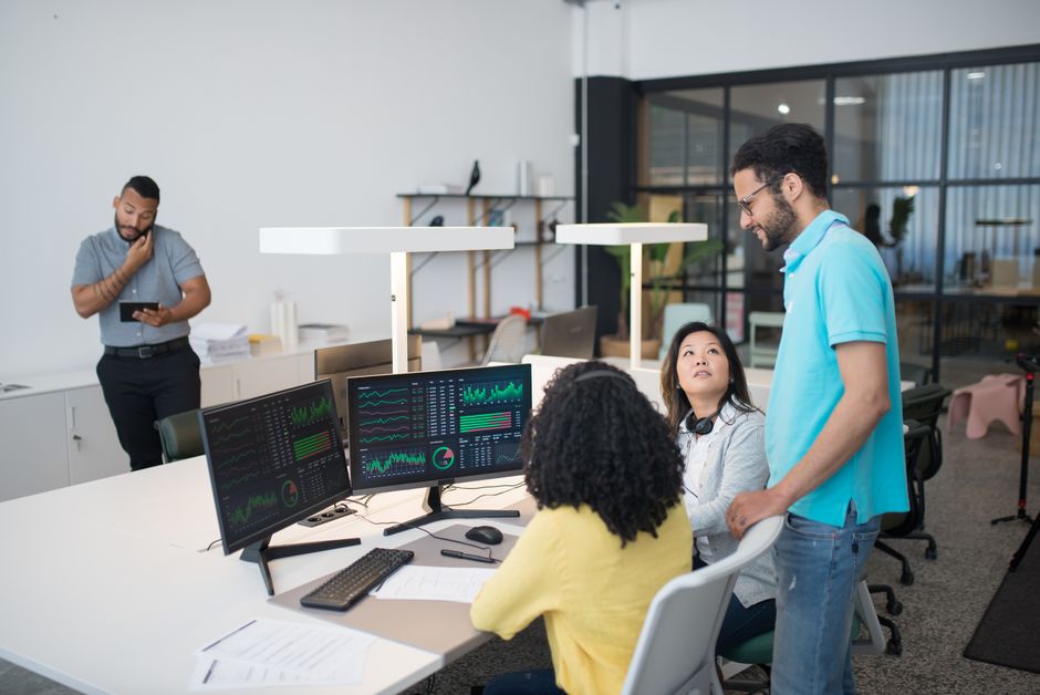 Office employees collaborating on financial data