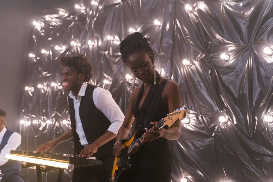 Live band performance with electric guitar and energetic musicians
