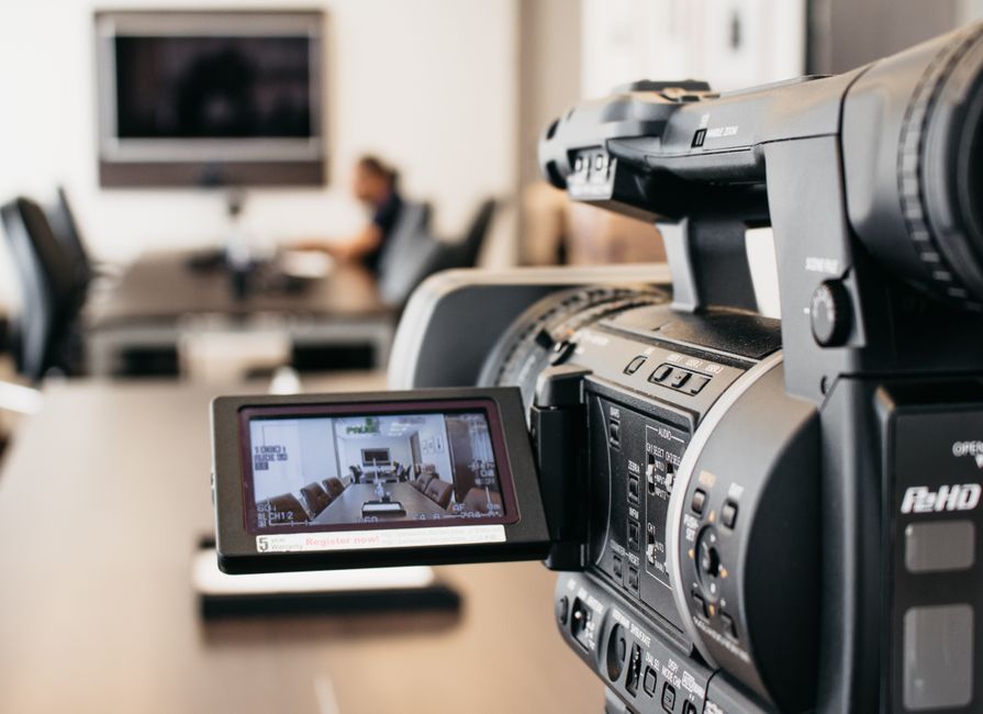 Professional video camera recording in modern office