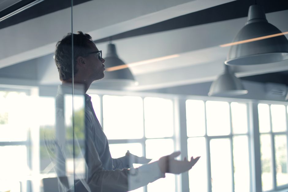 Businessman in glasses through glass view