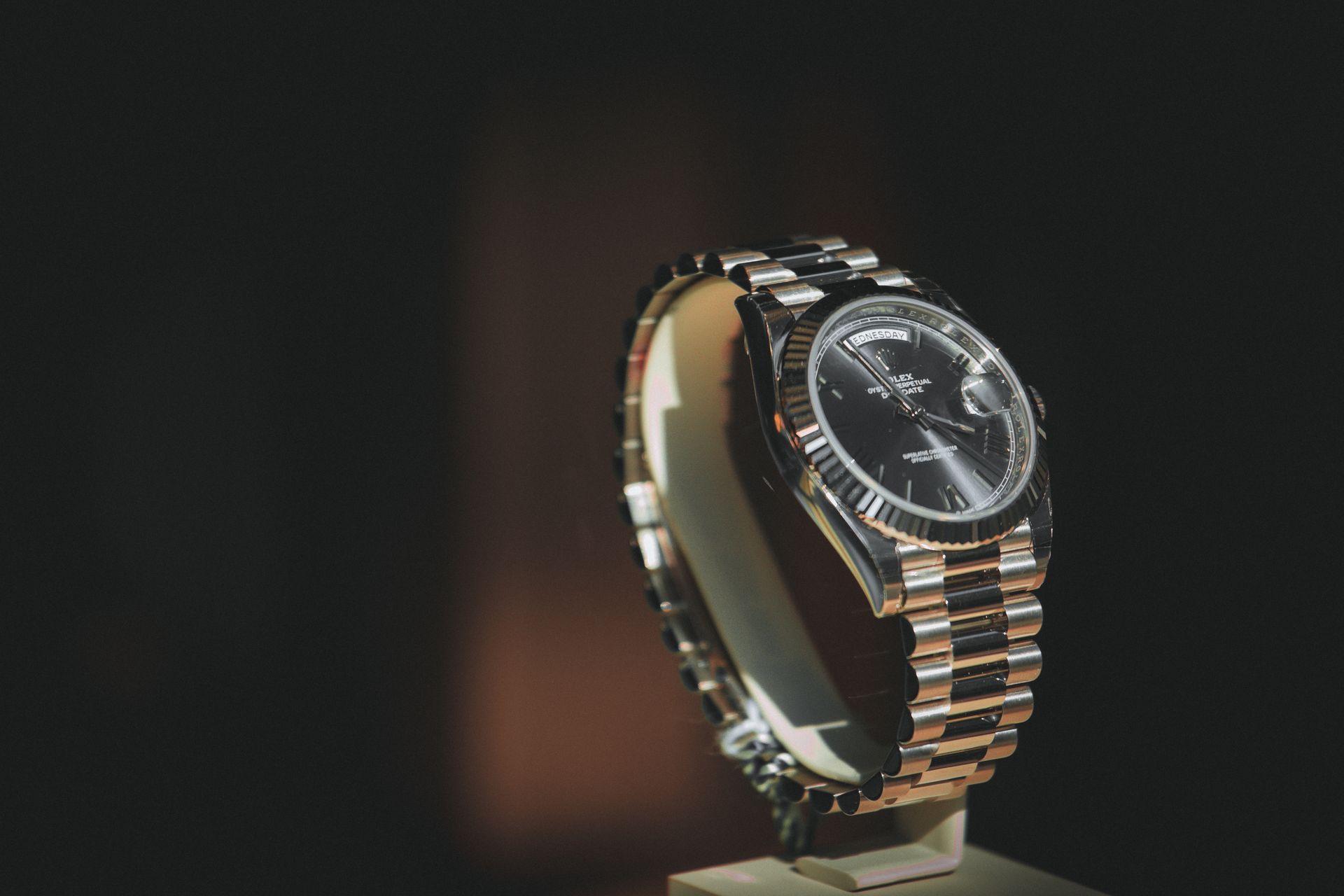 Browsing CJ William's online luxury watch inventory on a laptop