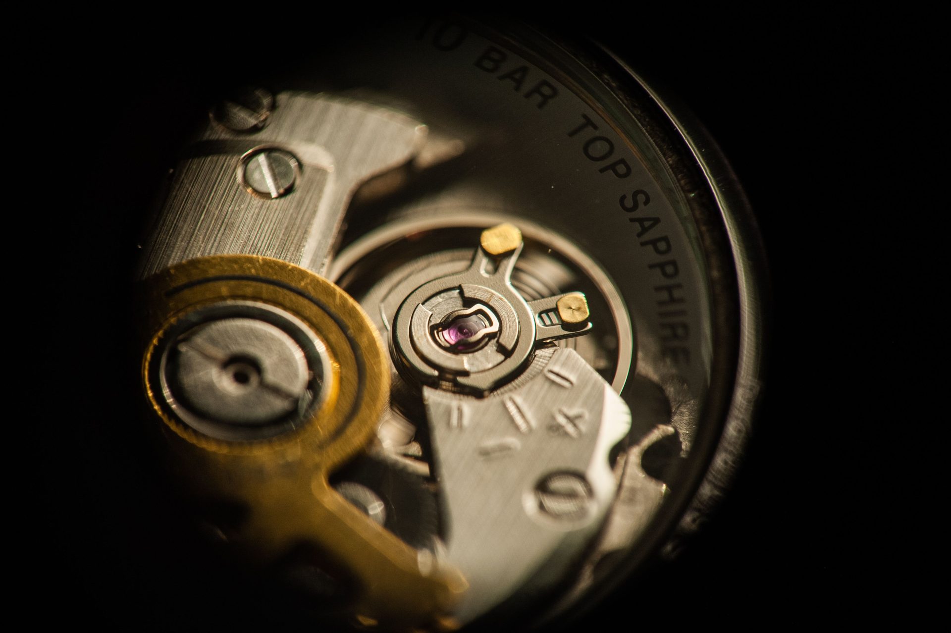 A watchmaker authenticating and testing a luxury watch movement in the service center