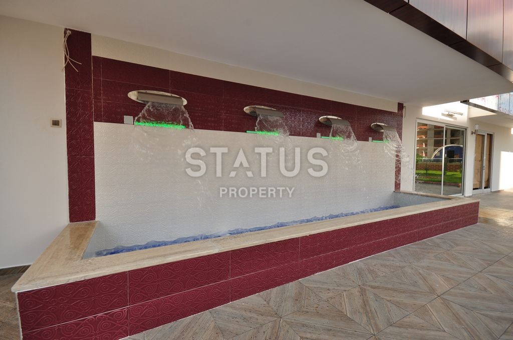 Меблированная просторная двухкомнатная квартира в комплексе с бассейном в Махмутларе, 75 м2. фото 16