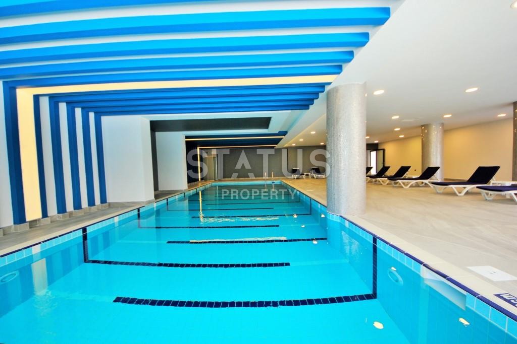 Апартаменты 1+1 в новом элитном комплексе на первой линии в Махмутларе, 55 м2. фото 9