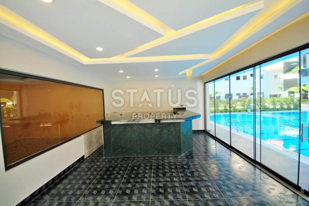 Апартаменты 1+1 в новом элитном комплексе на первой линии в Махмутларе, 55 м2. фото 21