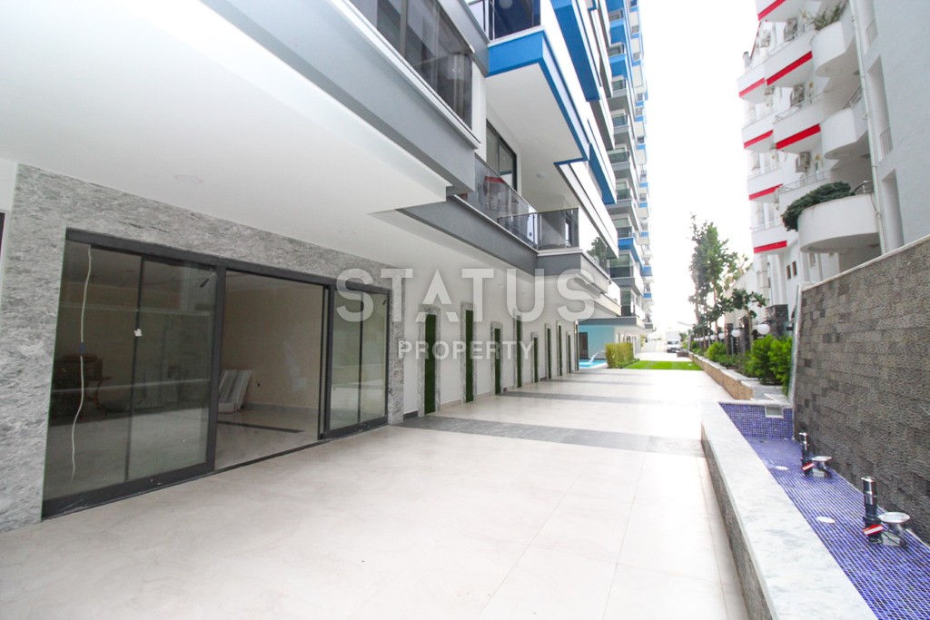 Апартаменты 1+1 в новом элитном комплексе на первой линии в Махмутларе, 55 м2. фото 22