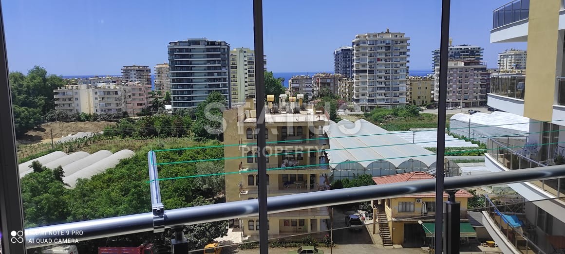 Квартира 55 кв.м. планировки 1+1 с видом на море в Махмутларе. фото 1