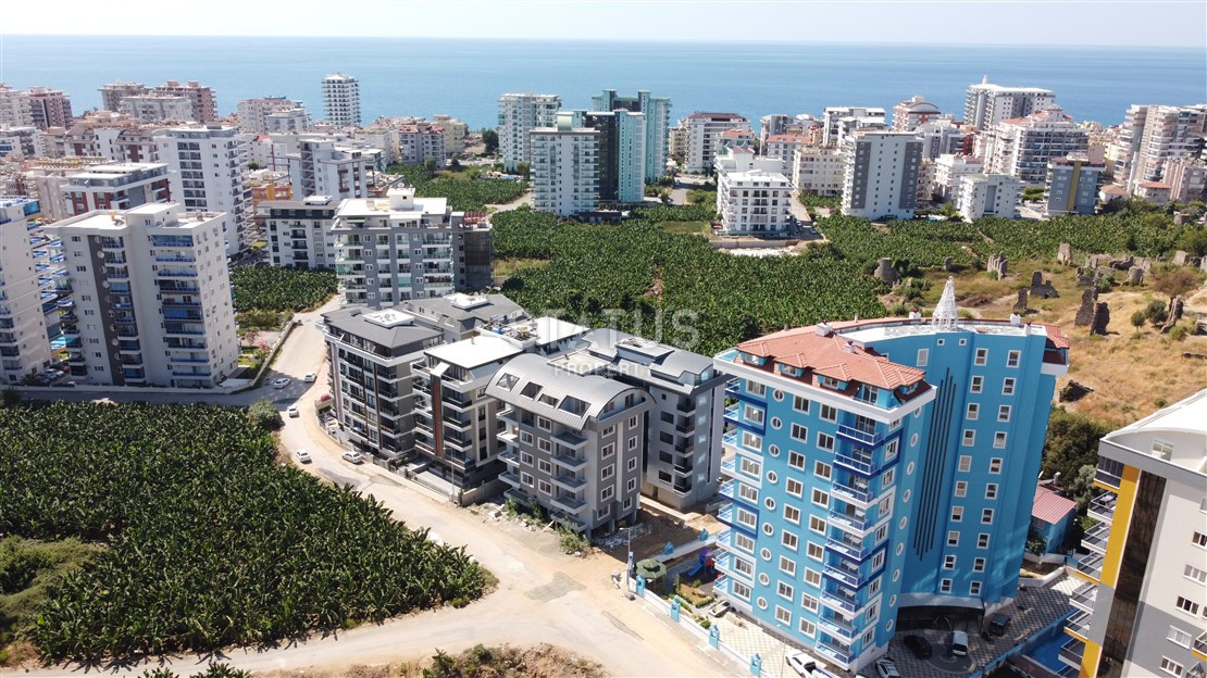 Квартира 1+1 с видом на Наулу в новом комплексе в Махмутларе, 55 м2. фото 1