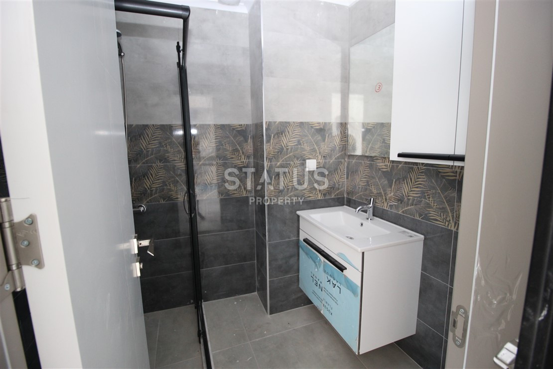 Квартира 1+1 с видом на Наулу в новом комплексе в Махмутларе, 55 м2. фото 5