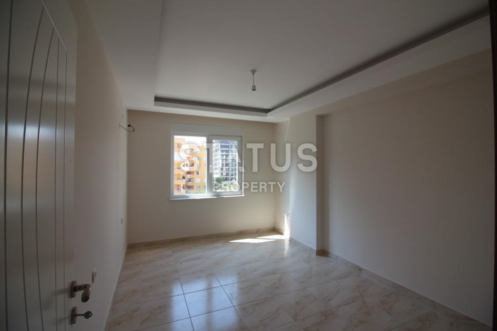 Новые апартаменты  в новом комплексе в самом центре Махмутлара. Большие площади и маленькие цены! 80 кв.м. фото 8