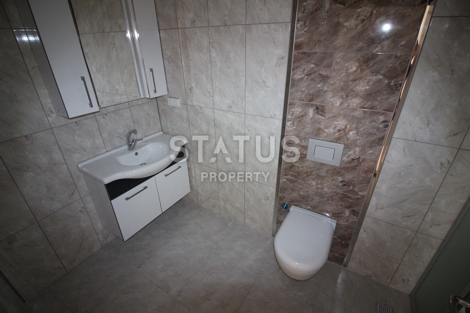 Новые апартаменты  в новом комплексе в самом центре Махмутлара. Большие площади и маленькие цены! 80 кв.м. фото 13