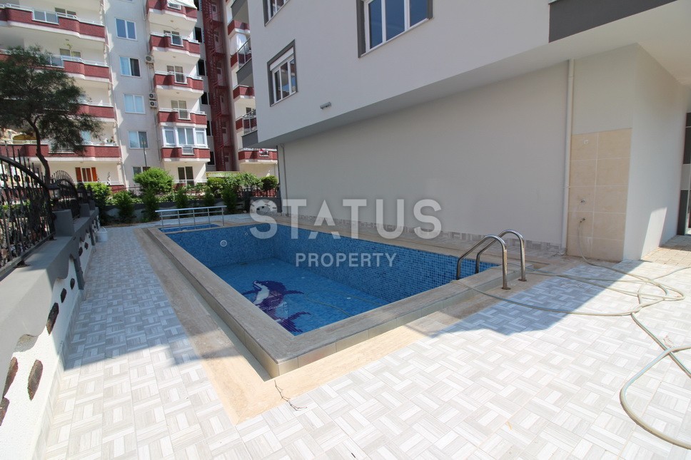 Новые апартаменты  в новом комплексе в самом центре Махмутлара. Большие площади и маленькие цены! 80 кв.м. фото 15