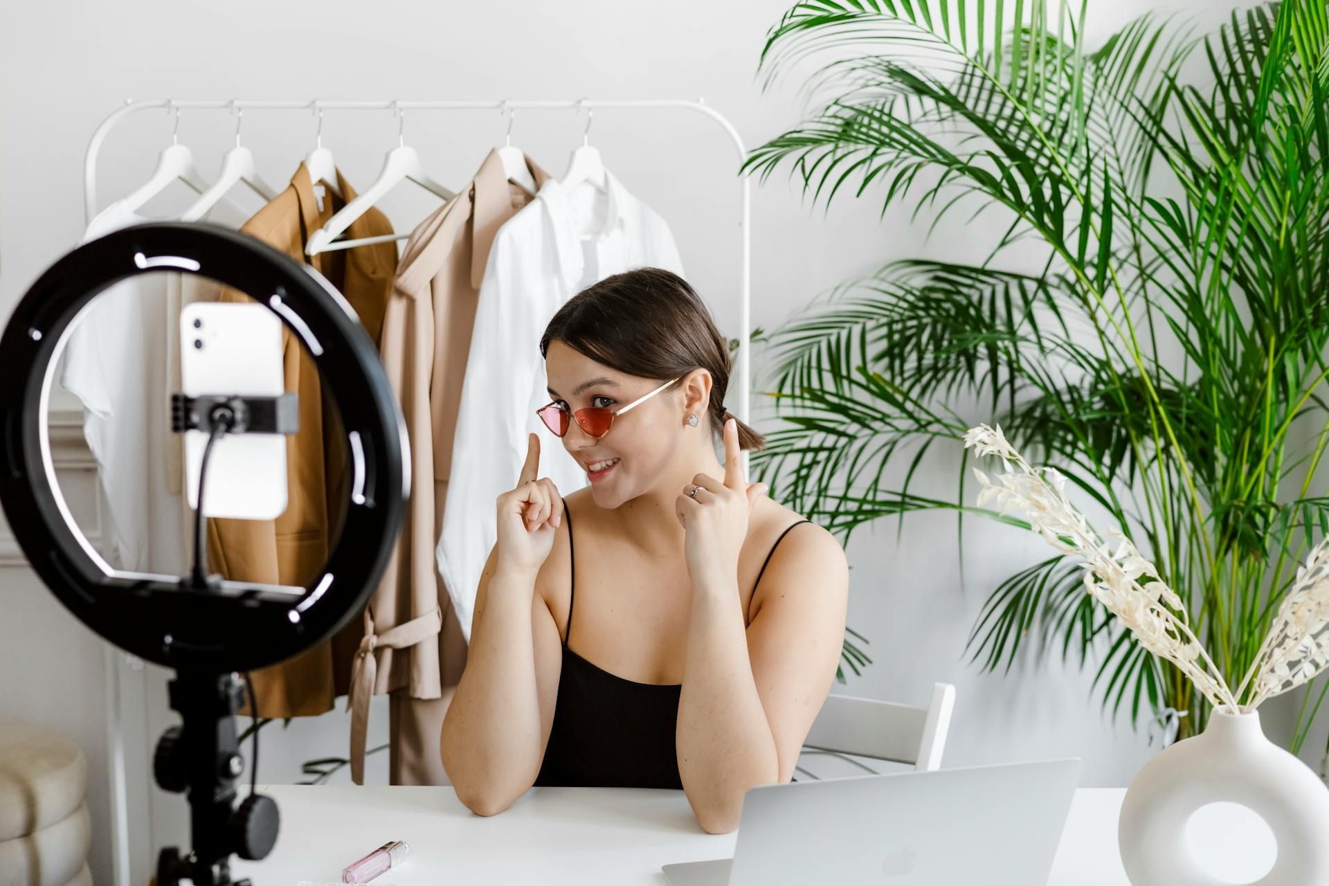 Woman filming herself with glasses on.