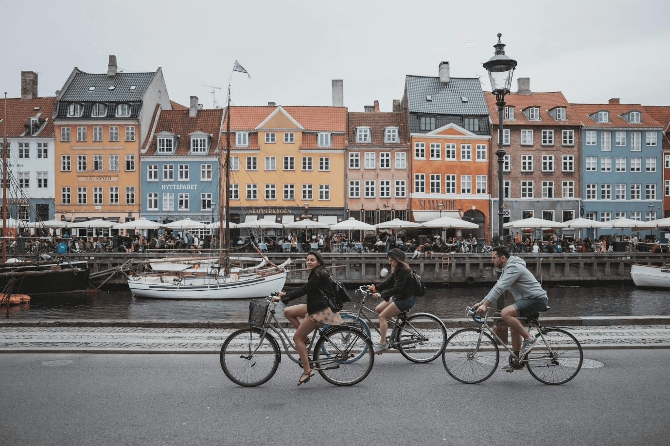 three people riding bicycles