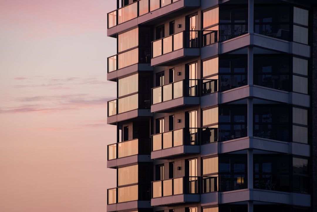 The exterior of an apartment building with balconies in daylight