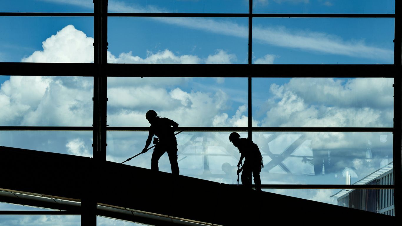 a few men working on a building
