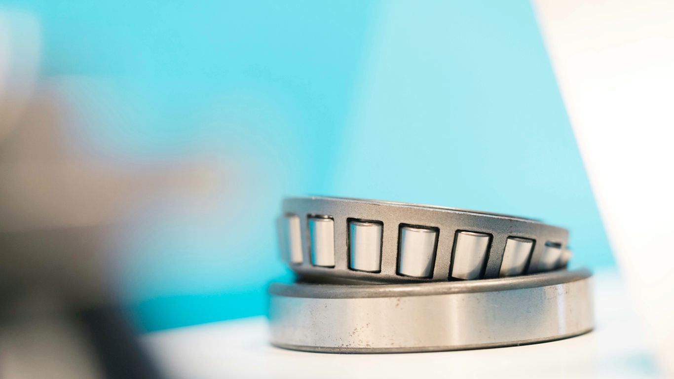 a close up of a metal object with a blue background