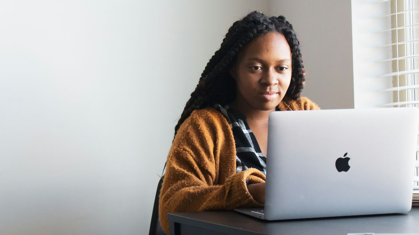 Professional managing customer data on a laptop