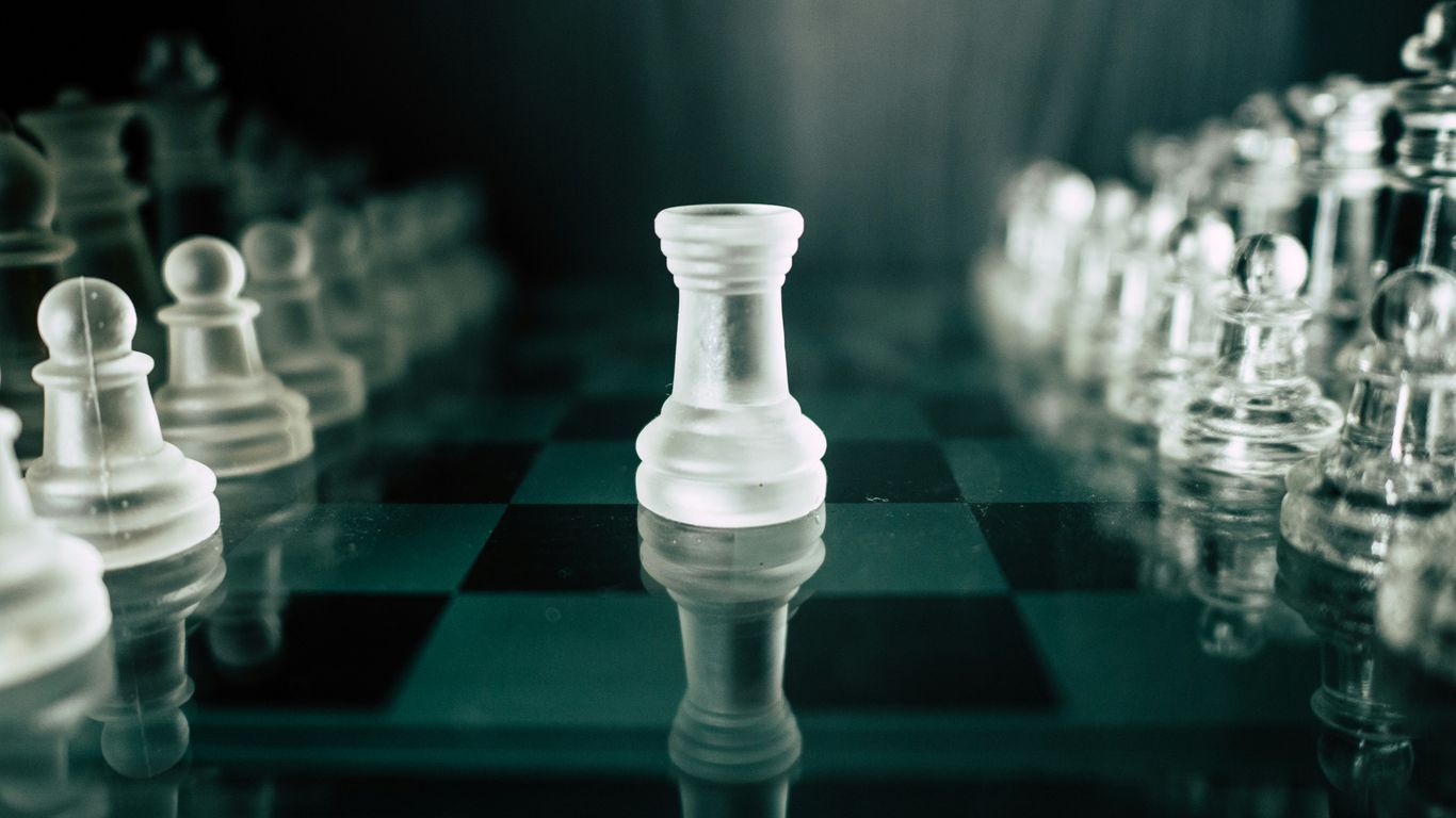 a black and white chess board with a white pawn
