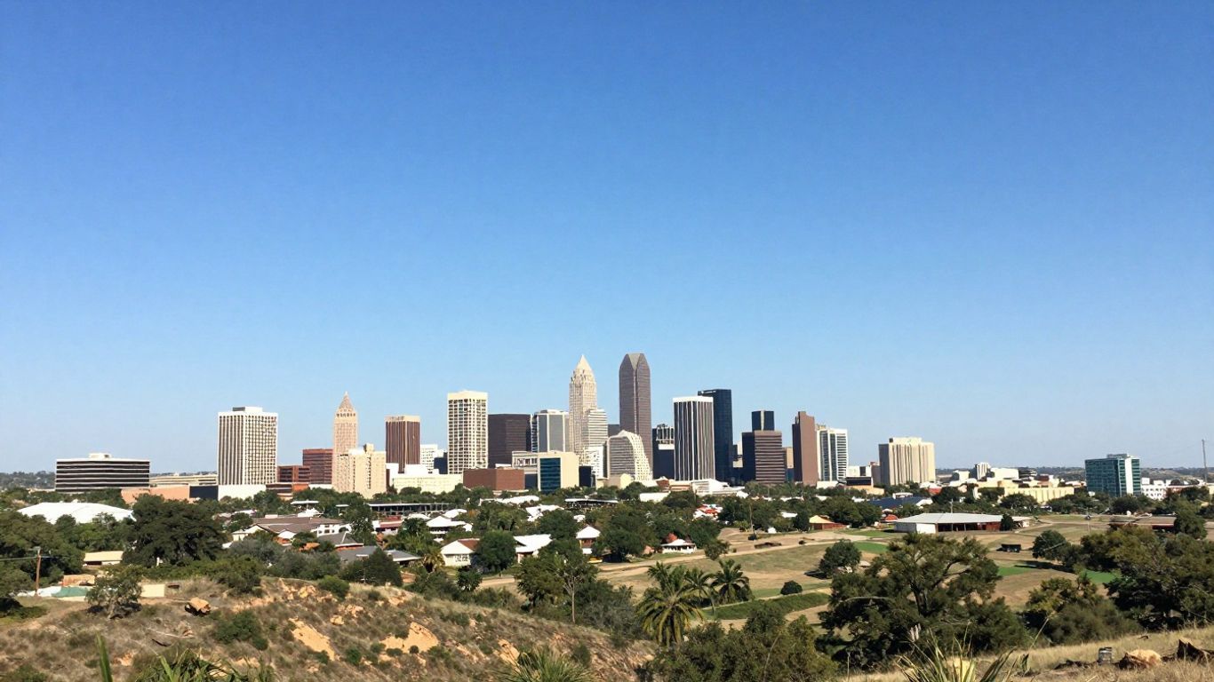 Texas landscape with distant city and rolling hills.