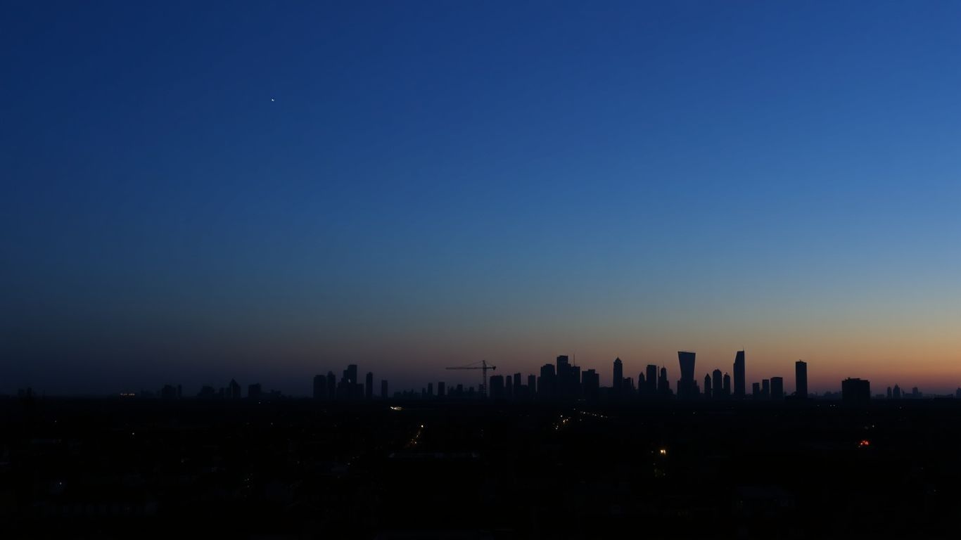 UK city skyline with residential rooftops and a twilight sky.