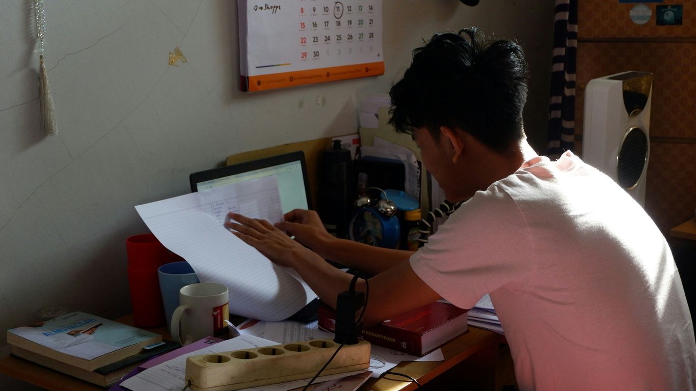 woman in white shirt sitting at the table