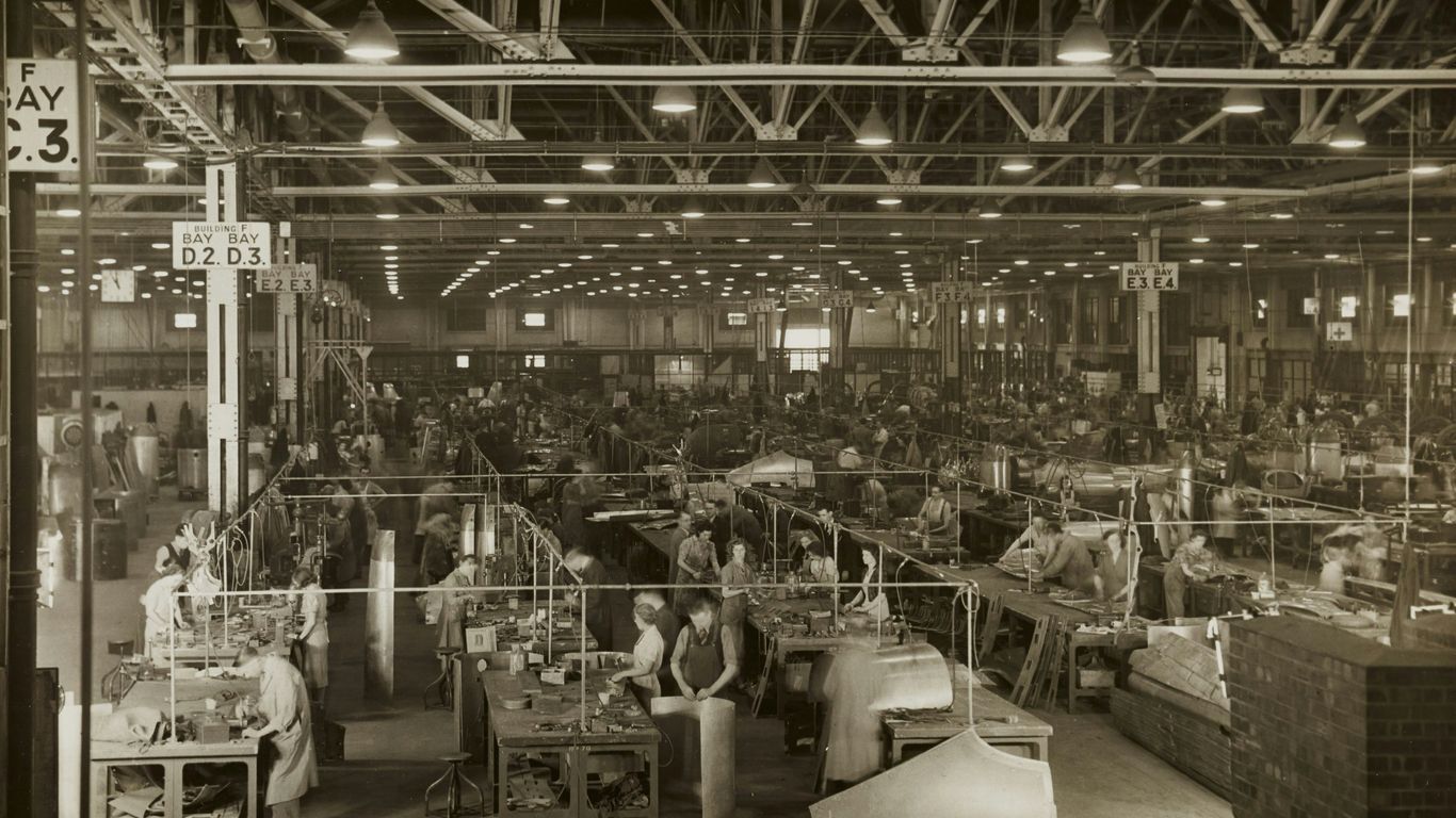 grayscale photo of people sitting on chairs