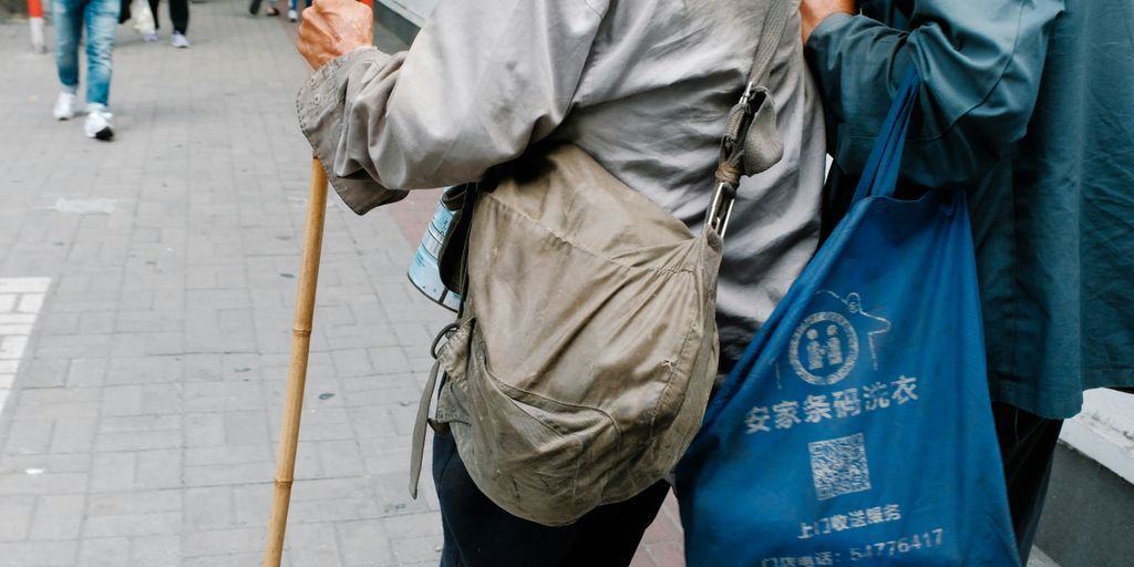 a couple of people walking down a street