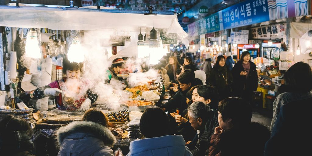 people walking and buying on busy street