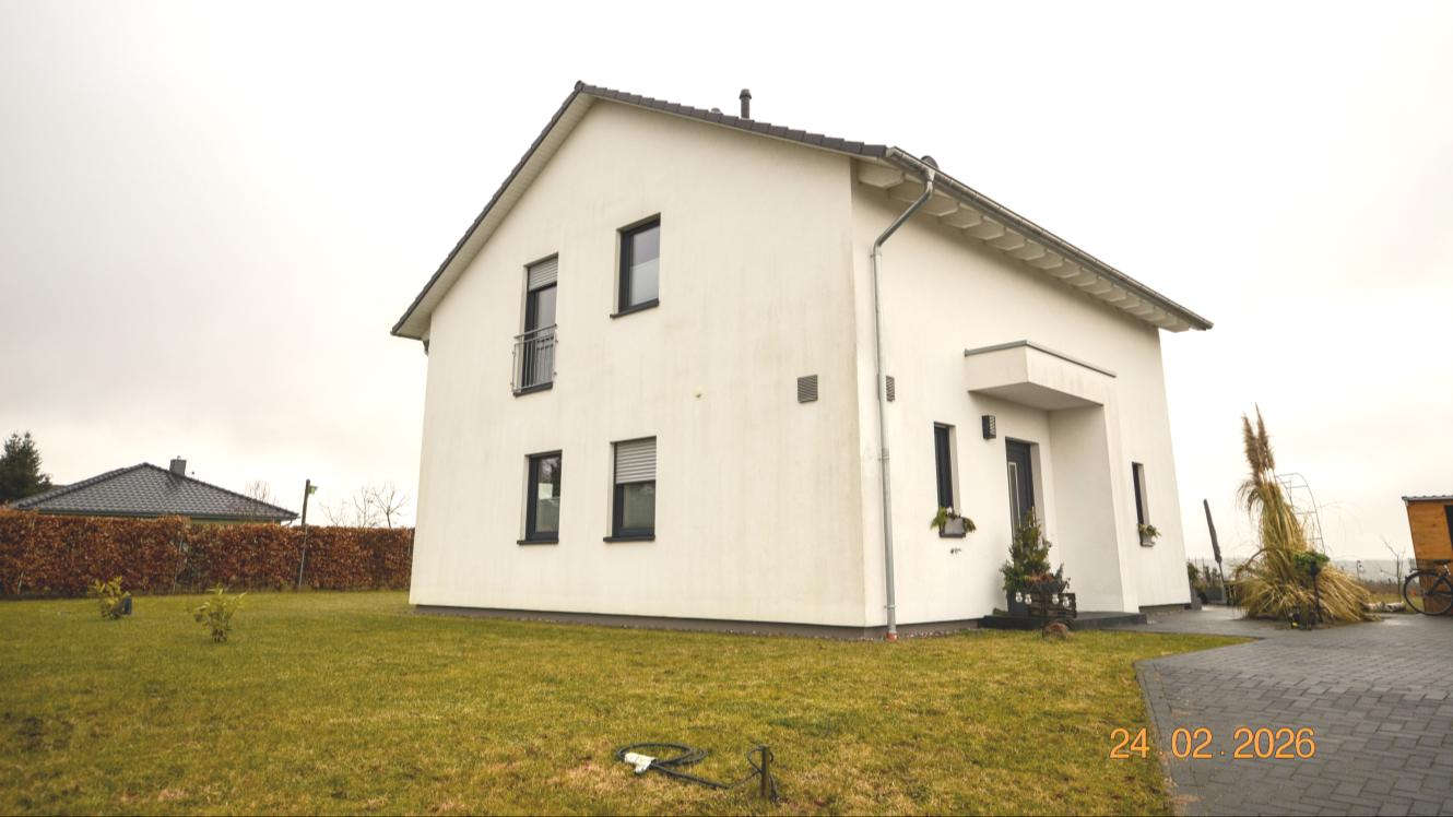 Einfamilienhaus in Nordwestuckermark, Horster Straße 18c, weiß verputzt, zweigeschossig, mit dunklen Fensterrahmen und Vorgarten