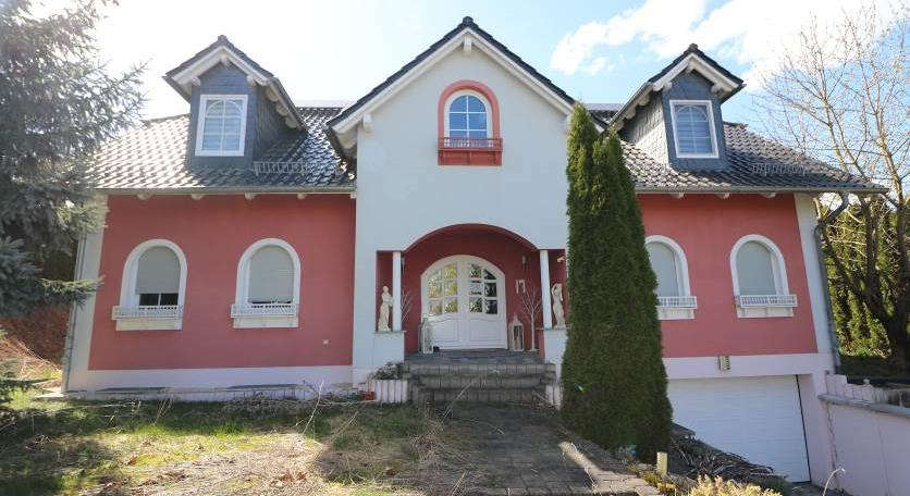 Einfamilienhaus in Nemsdorf-Göhrendorf, Krausentaler Weg 17, mit roter und weißer Fassade, Satteldach, Dachgauben und Eingangsbereich mit Stufen und Säulen