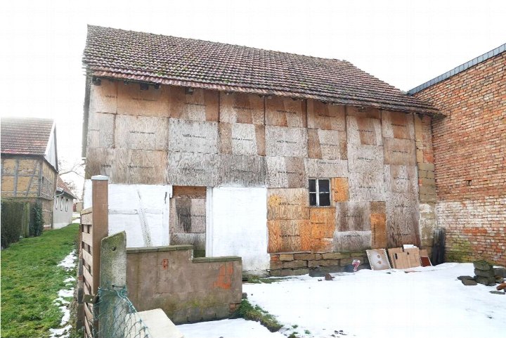 Seitenansicht eines Gebäudes mit Holzverkleidung und Ziegelfassade, Schnee auf dem Boden, Gartenweg links, Freienbessingen, Pfarrecke 2